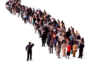 Photo of many people standing in a long queue